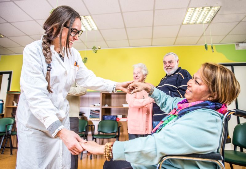 Senior adults in a nursing home for the elderly having fun and dancing